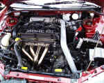 GReddy stainless steel header and AEM cold air intake in Dodge Avenger
