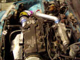 Side view of engine bay after installation of GReddy turbo kit