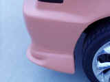 Closeup of flares molded into rear bumper after priming
