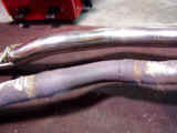 Closeup of Espelir downpipe versus OEM crush bends and multipiece pipe