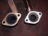Closeup of Espelir downpipe versus OEM flange that tapers down to smaller pipe