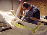 Shawn smoothing edges after removing part of the fiberglass to give it a clean appearance after installation
