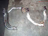 Borla header (left) compared to OEM exhaust manifold (right)