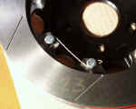 Closeup of front Wilwood two piece slotted rotor safety wired