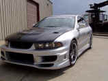 Closeup of JDM headlights and ViS Racing Sports front bumper and NIN Autosports carbon fiber hood